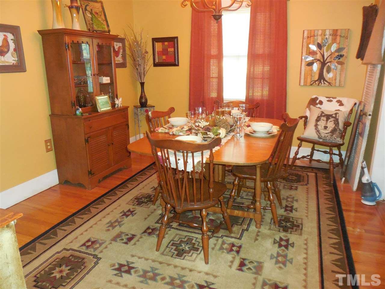 2150 Sanders Road Stem, NC 27581 - Photo 12 of 13 a view of a dining room with furniture and wooden floor