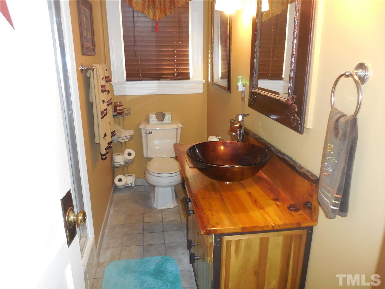 2150 Sanders Road Stem, NC 27581 - Photo 13 of 13 a bathroom with a sink and a toilet