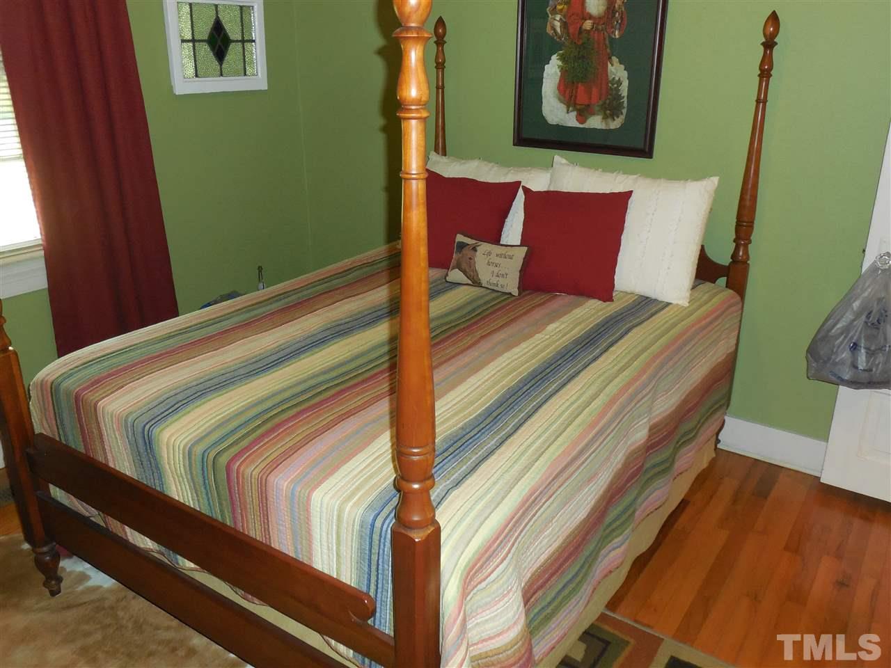 2150 Sanders Road Stem, NC 27581 - Photo 10 of 13 a bedroom with a bed and wooden floor