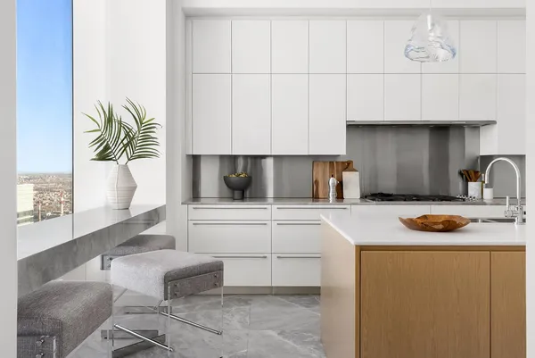a kitchen with kitchen island a sink appliances and cabinets