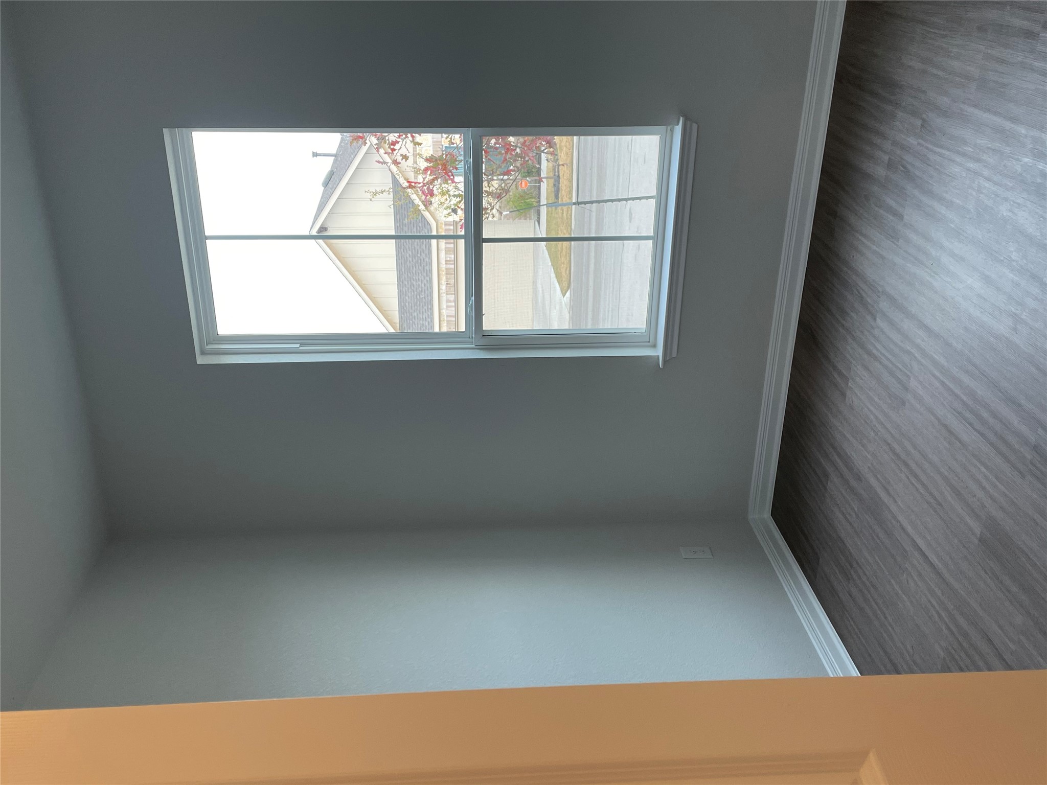3908 Birdwatch Loop, Unit 56 Pflugerville, TX 78660 - Photo 5 of 30 an empty room with wooden floor and windows