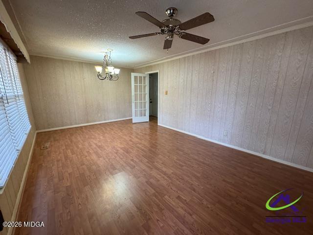 309 North Pleasant Hill Road Warner Robins, GA 31093 - Photo 11 of 23 an empty room with wooden floor chandelier fan and windows