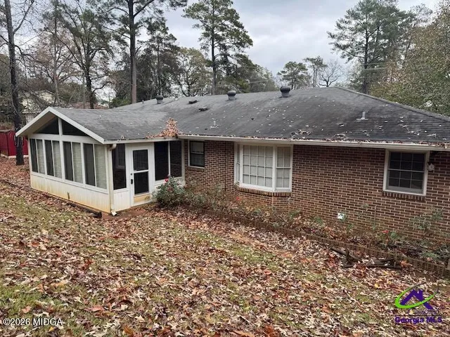a house with trees in the background