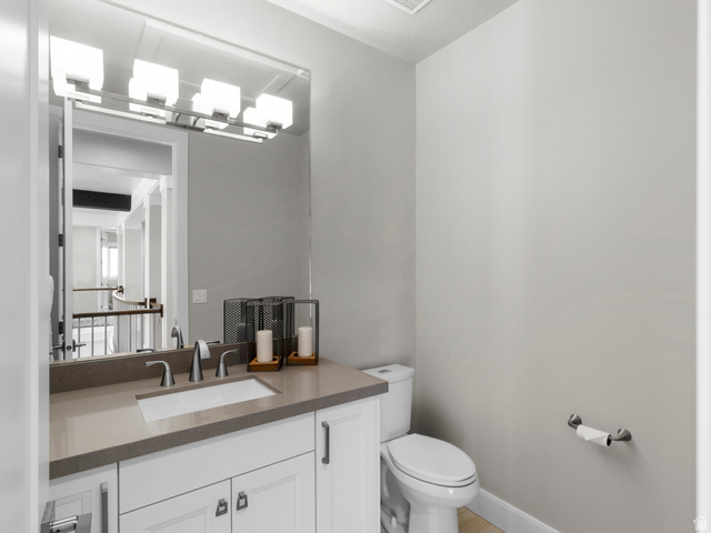 614 East High Lane Alpine, UT 84004 - Photo 64 of 75 Half bath with vanity and toilet