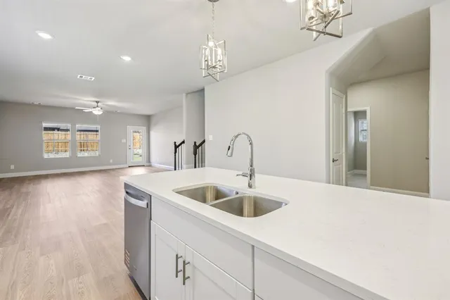 a kitchen with a sink and chandelier