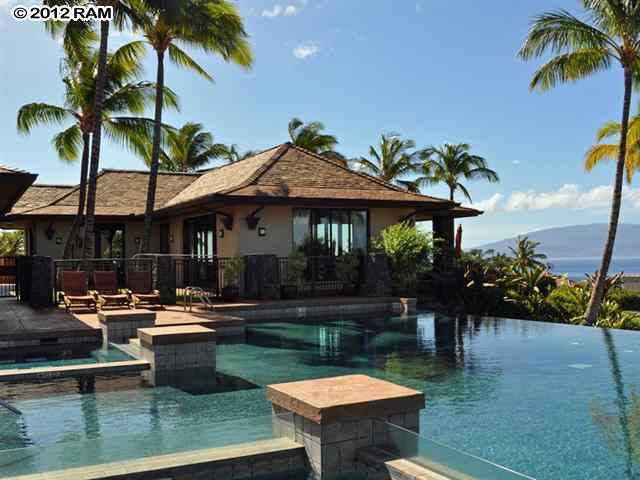 44 Anapuni Loop, Unit 3 Lahaina, HI 96761 - Photo 10 of 18 a patio with a table and chairs pool and a fire pit