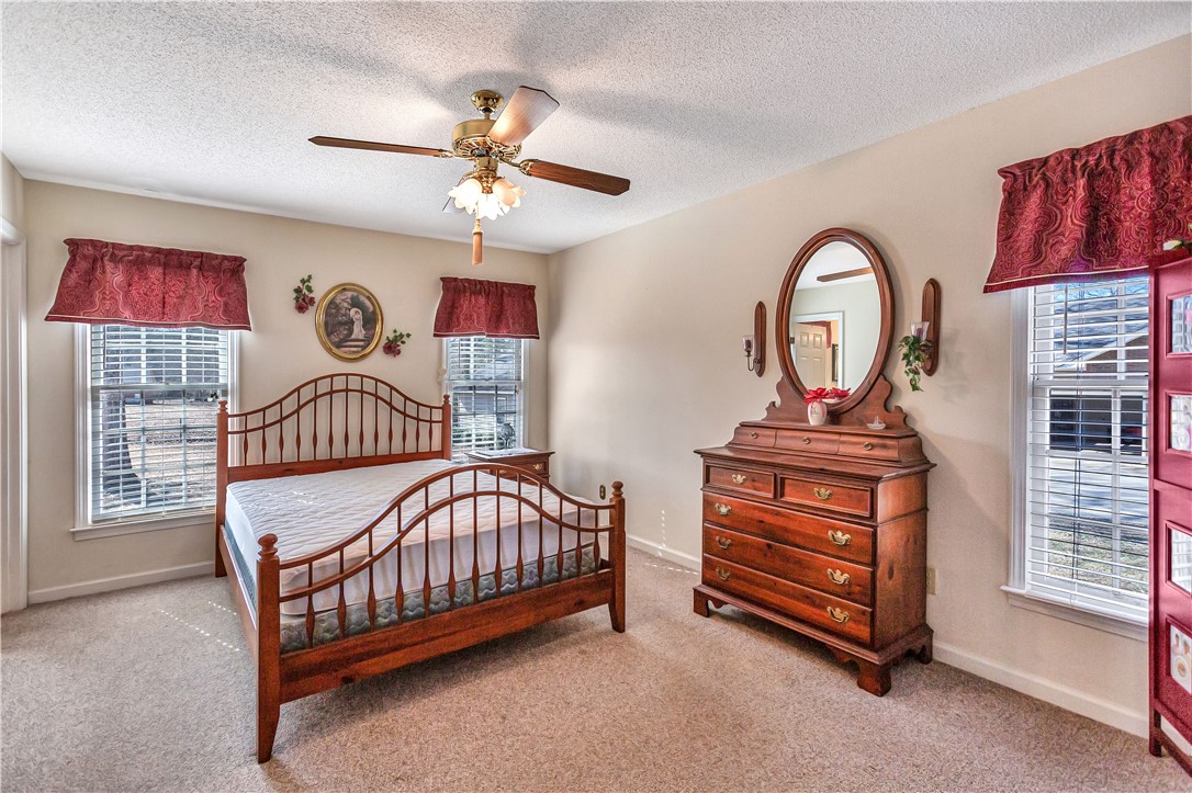 1116 Green Willow Trail Anderson, SC 29621 - Photo 18 of 45 This spacious bedroom offers ample natural light and a classic aesthetic.