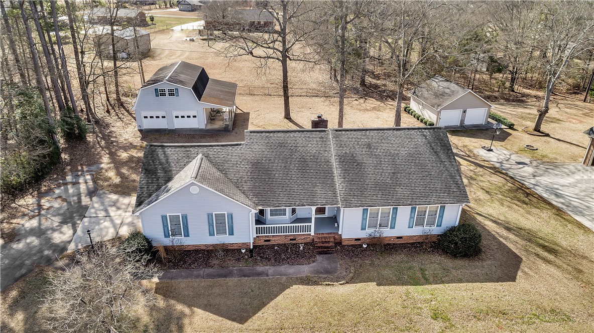 1116 Green Willow Trail Anderson, SC 29621 - Photo 40 of 45 This expansive property features a charming residence with a broad front porch, nestled among mature trees.