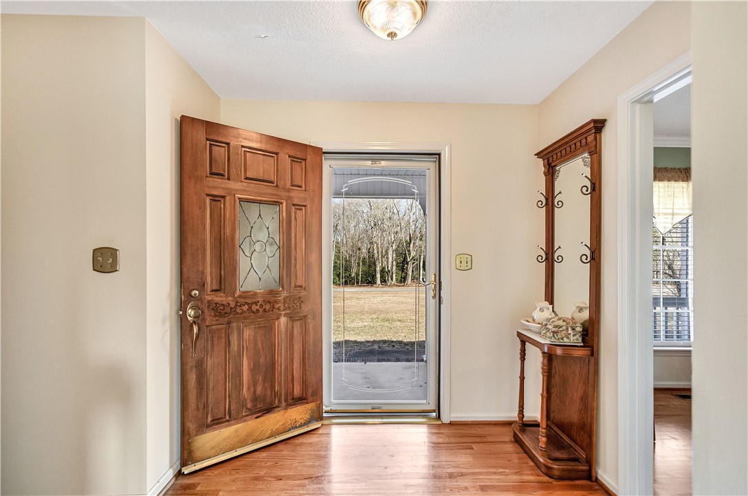 1116 Green Willow Trail Anderson, SC 29621 - Photo 4 of 45 The inviting entryway features gleaming wood flooring and a classic wooden door with decorative glass.