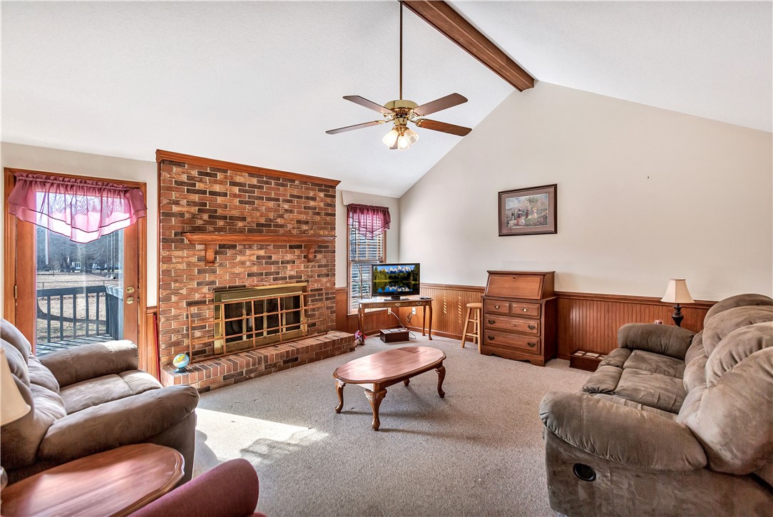 1116 Green Willow Trail Anderson, SC 29621 - Photo 6 of 45 This inviting living area boasts a vaulted ceiling and a classic brick fireplace, creating a warm atmosphere.