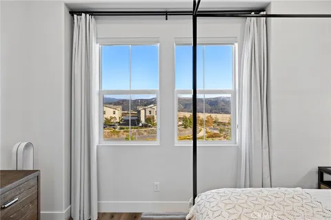 a bedroom with a bed and a chair