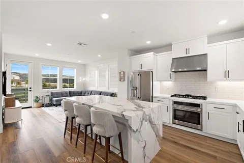 a large white kitchen with a table and chairs