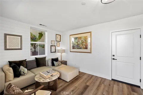 a living room with furniture and a painting on the wall