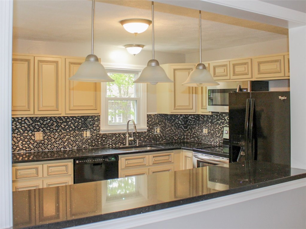 43 Overhill Road Warren, RI 02885 - Photo 4 of 21 The wide pass-through from kitchen to living room, featuring a large stone counter top - great as a breakfast bar or additional counter space.