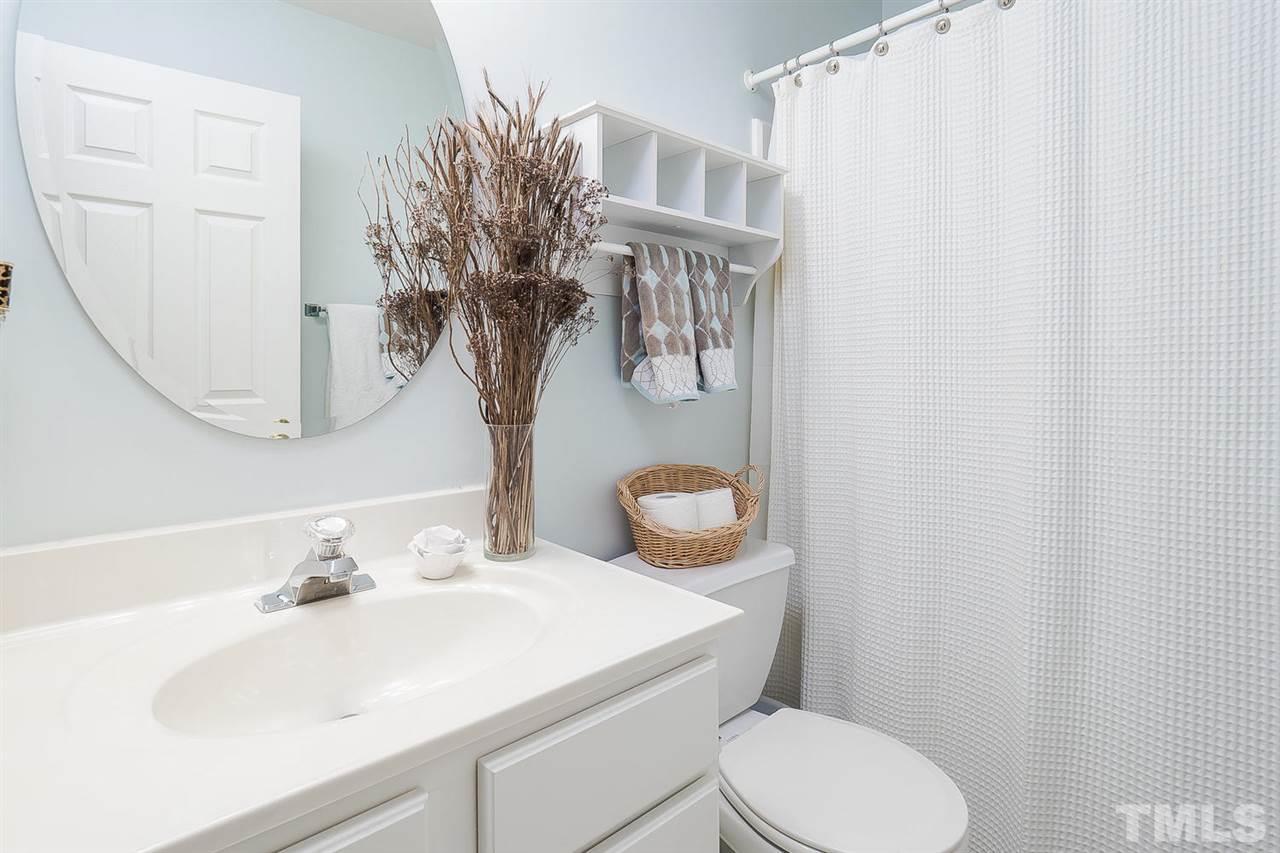 4714 Longhill Lane Raleigh, NC 27612 - Photo 13 of 19 a bathroom with a sink toilet and mirror