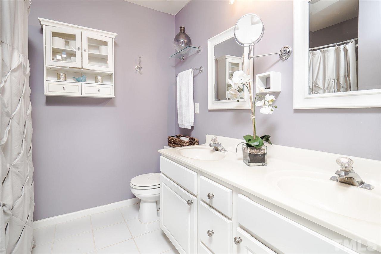 4714 Longhill Lane Raleigh, NC 27612 - Photo 10 of 19 a bathroom with a sink a toilet and a mirror