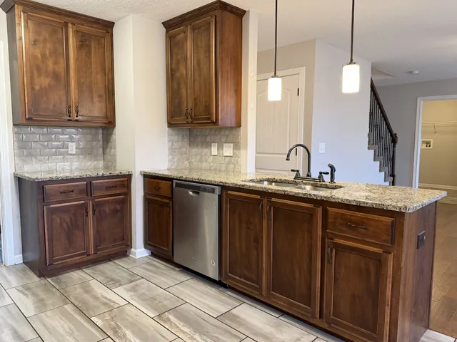a kitchen with stainless steel appliances granite countertop a sink and cabinets