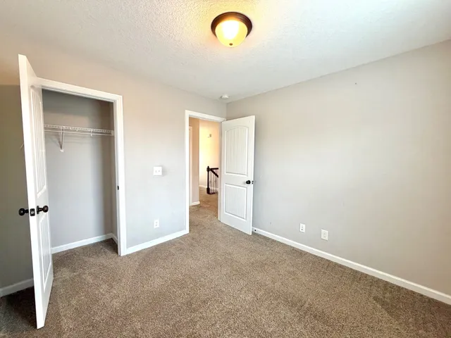 an empty room with a cabinet and mirror