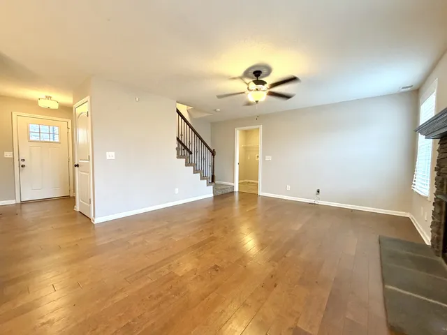 a view of a livingroom with a ceiling fan and window