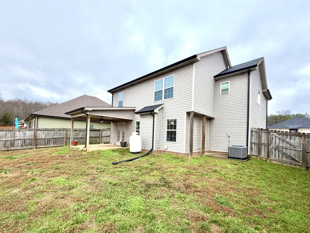 a house with swimming pool in front of it
