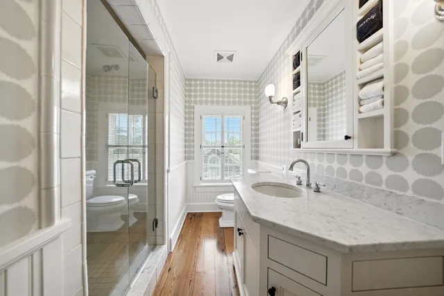a bathroom with a granite countertop sink toilet and shower