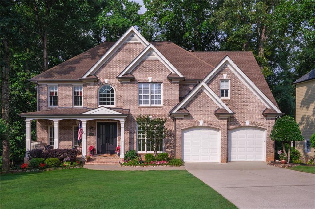 4330 Farmbrook Lane Cumming, GA 30041 - Photo 1 of 46 a front view of a house with a yard and trees