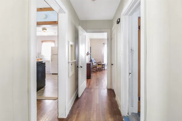 a view of a hallway with wooden floor