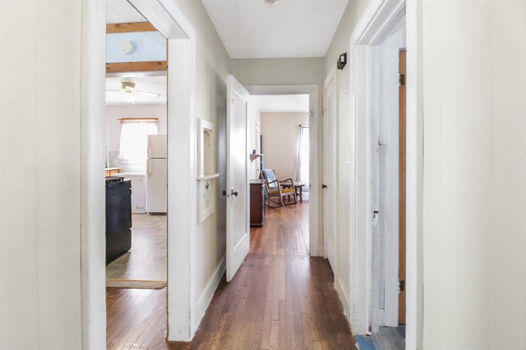 605 West Walnut Street Coleman, TX 76834 - Photo 11 of 18 a view of a hallway with wooden floor