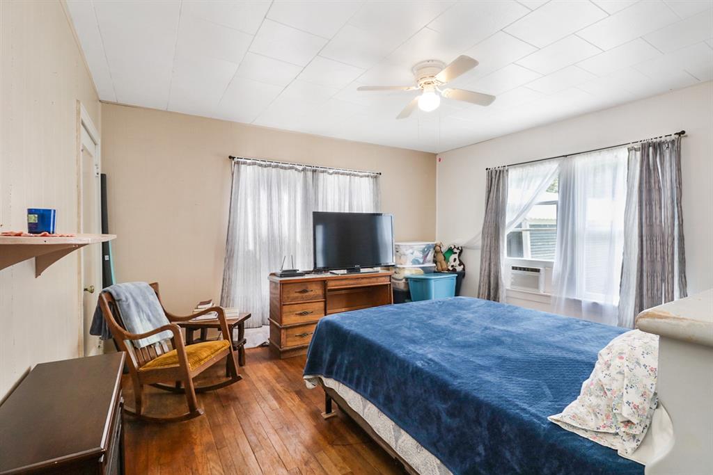 605 West Walnut Street Coleman, TX 76834 - Photo 12 of 18 a bedroom with a bed and a flat screen tv