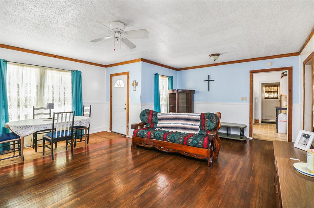 605 West Walnut Street Coleman, TX 76834 - Photo 2 of 18 a bedroom with furniture and wooden floor