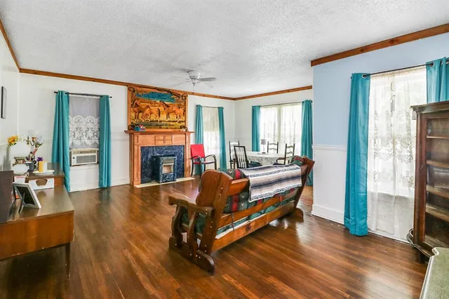 a living room with furniture a fireplace and a flat screen tv