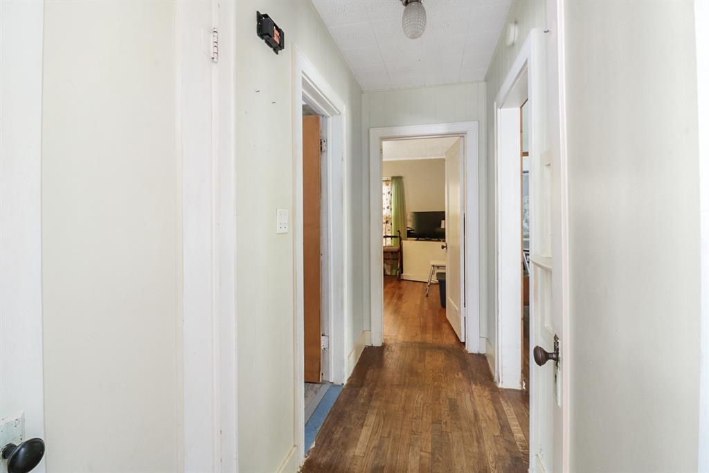 605 West Walnut Street Coleman, TX 76834 - Photo 7 of 18 a view of a hallway with a wooden floor