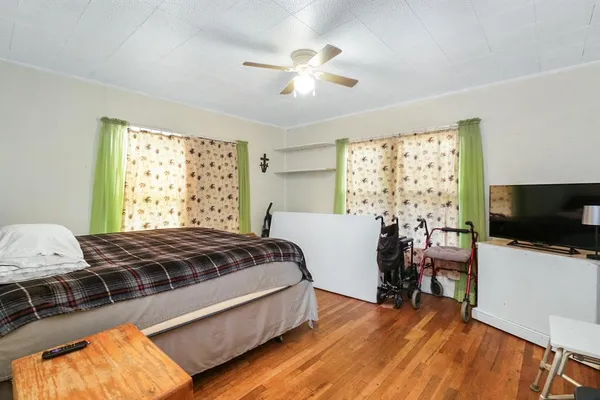 a bed room with a bed and a television