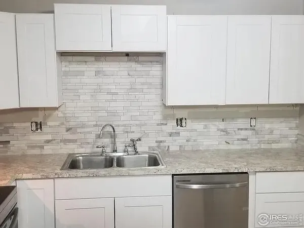 a kitchen with stainless steel appliances granite countertop a sink and cabinets