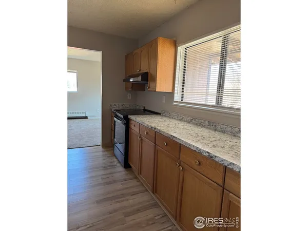 a kitchen with stainless steel appliances granite countertop a sink and wooden cabinets