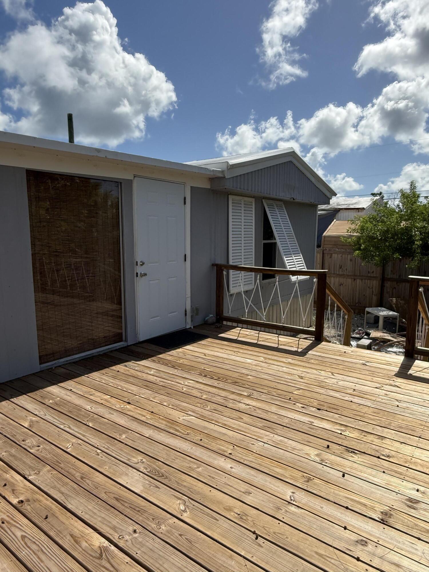 27960 Porgie Path Summerland Key, FL 33042 - Photo 8 of 30 a bedroom with a bed and a chandelier