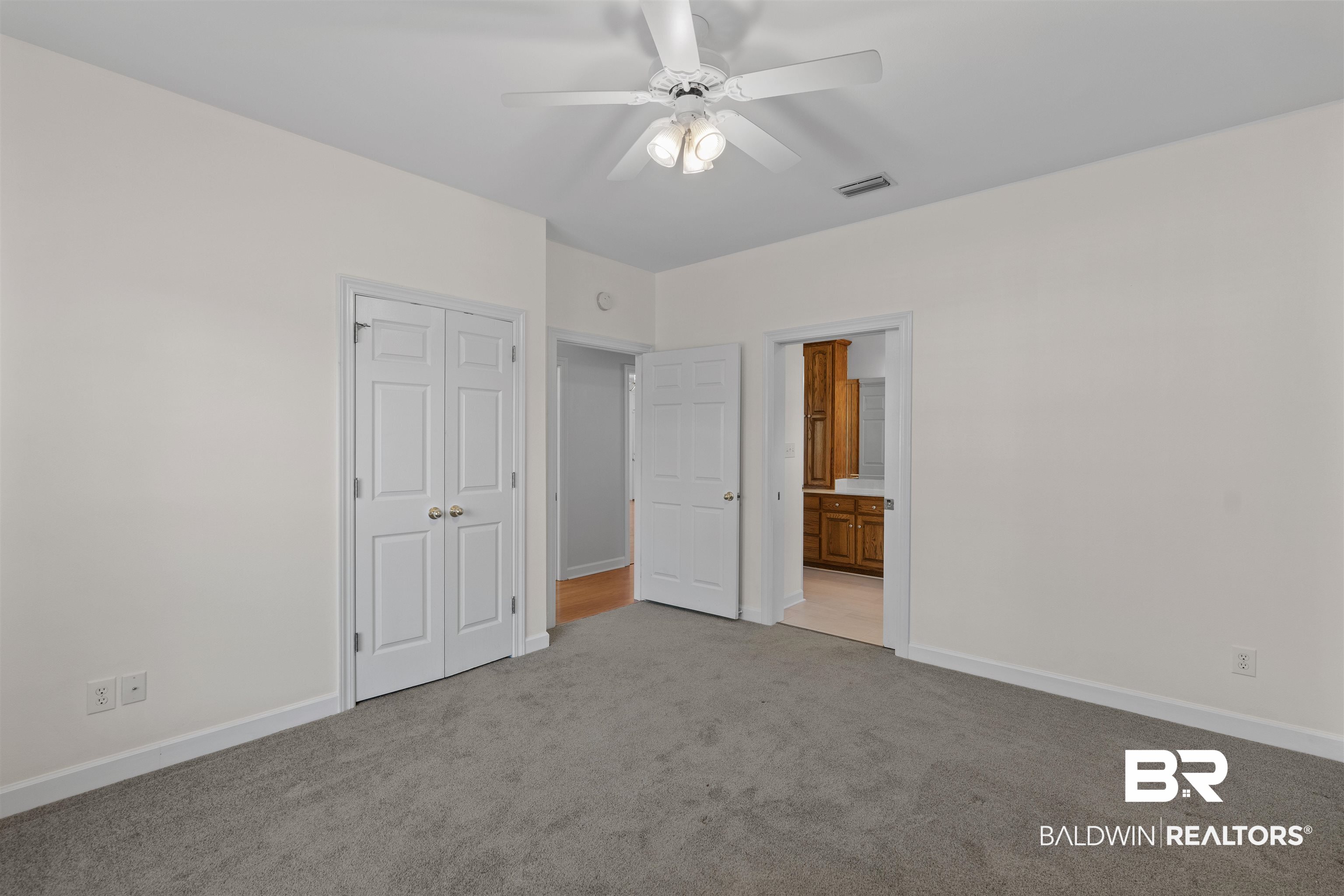 4 Judd Trail Daphne, AL 36527 - Photo 34 of 45 Unfurnished bedroom with light colored carpet, visible vents, a closet, and baseboards