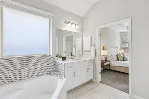 a spacious bathroom with a bathtub and a sink