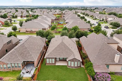 an aerial view of residential houses with outdoor space
