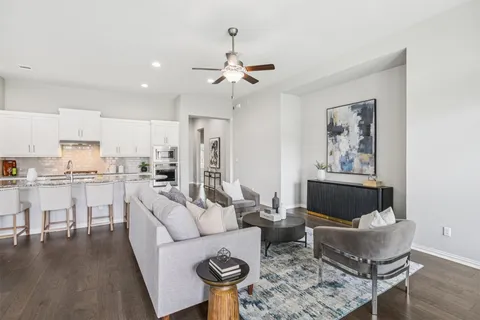 a living room with furniture and kitchen view