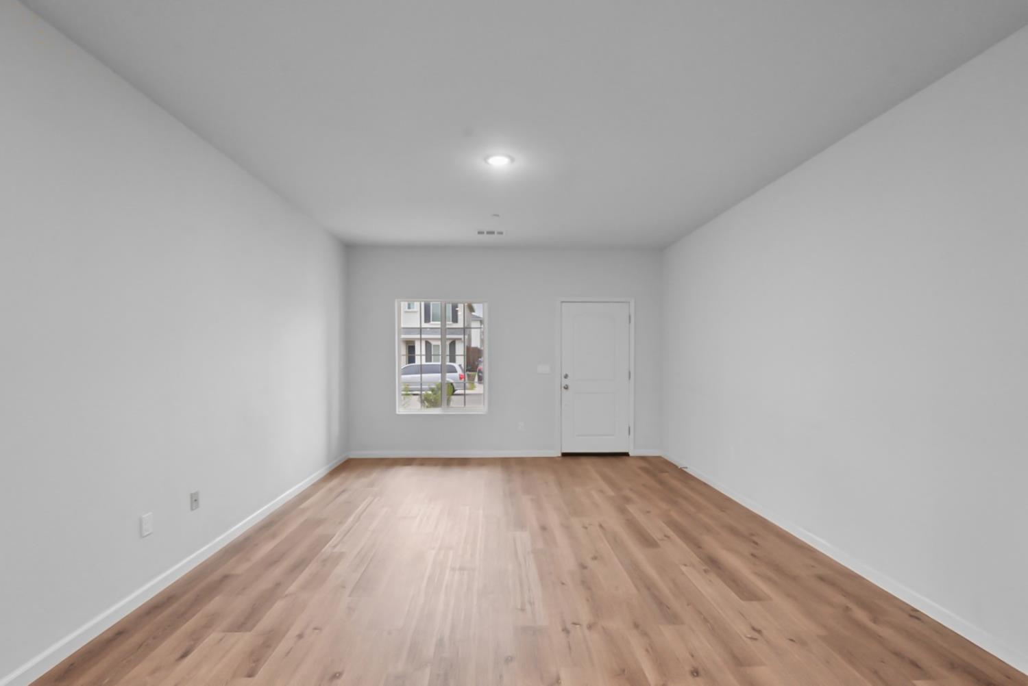 683 Granada Court Merced, CA 95341 - Photo 3 of 9 a view of a room with wooden floor and window