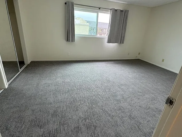 a view of an empty room and a window