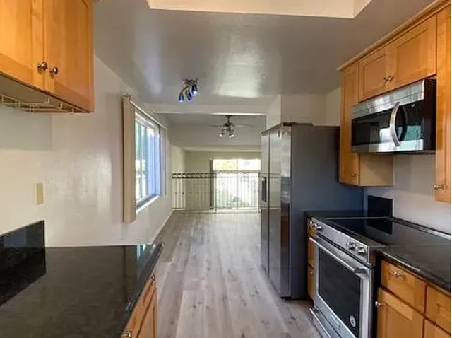 a kitchen with stainless steel appliances a refrigerator stove and microwave