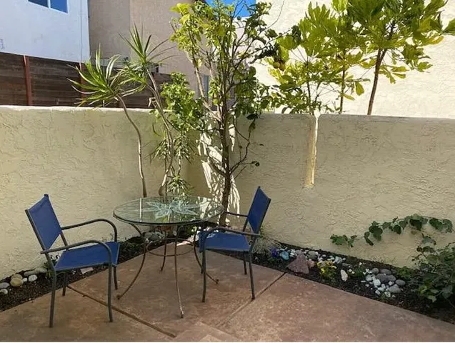 a view of a chairs and table in the patio