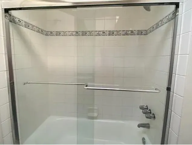a bathroom with a shower and a shower