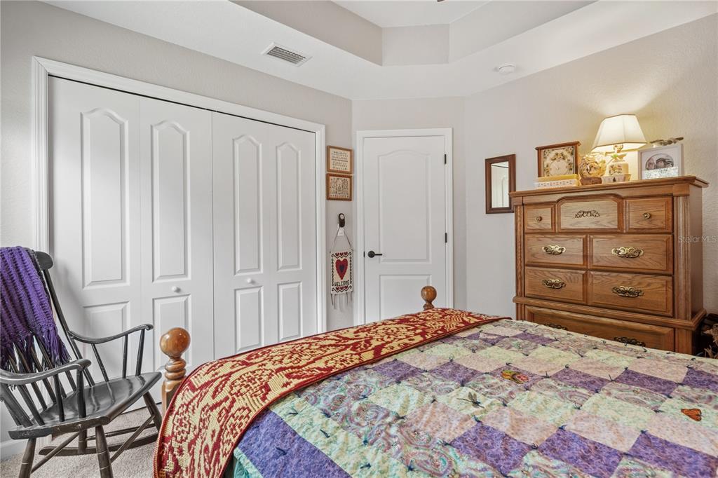 12929 Southwest 89th Street Dunnellon, FL 34432 - Photo 26 of 76 a bedroom with a bed and a dresser in it