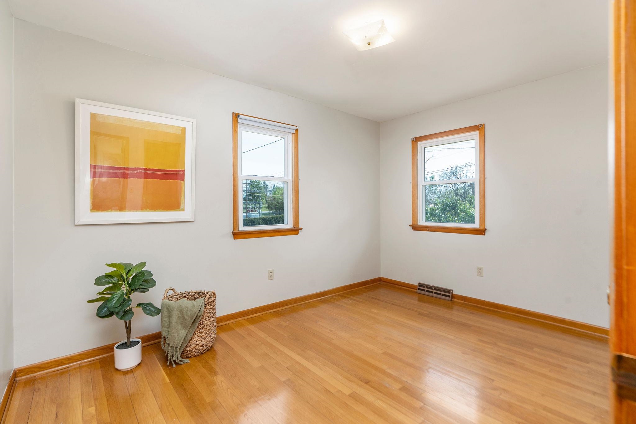 2209 3rd Street Staunton, VA 24401 - Photo 18 of 35 a view of a bedroom with wooden floor and a potted plant
