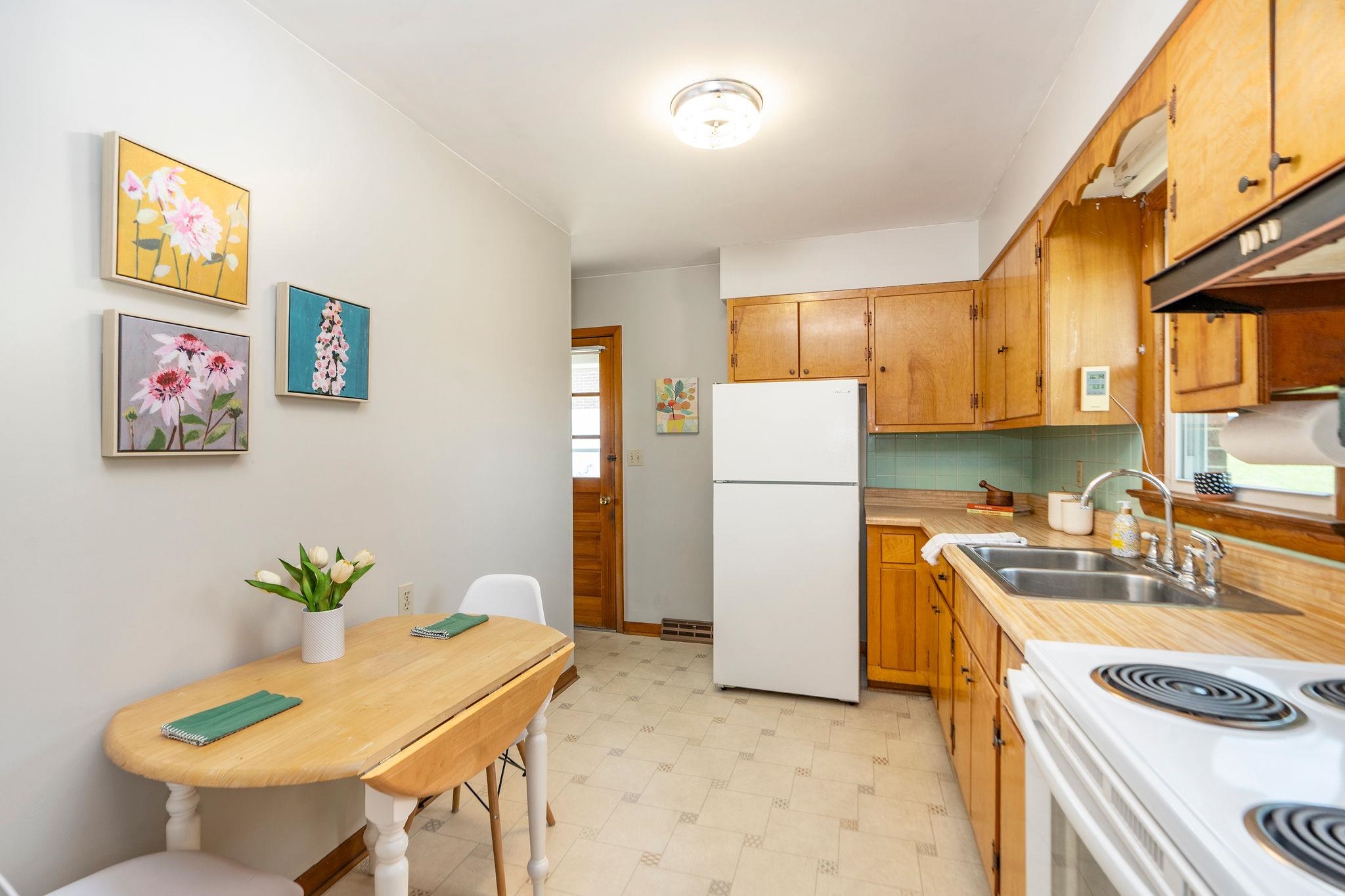 2209 3rd Street Staunton, VA 24401 - Photo 7 of 35 a kitchen with a refrigerator and a table