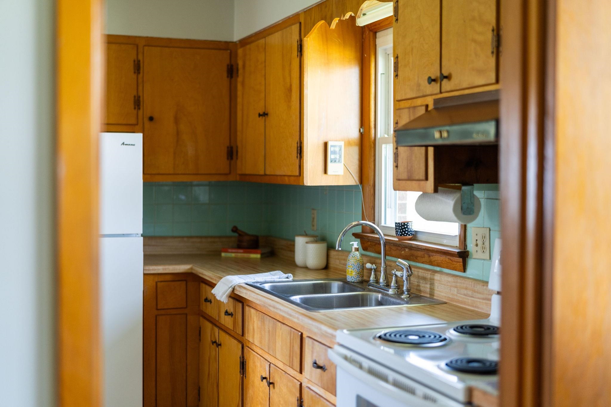 2209 3rd Street Staunton, VA 24401 - Photo 9 of 35 a kitchen with a sink and a refrigerator