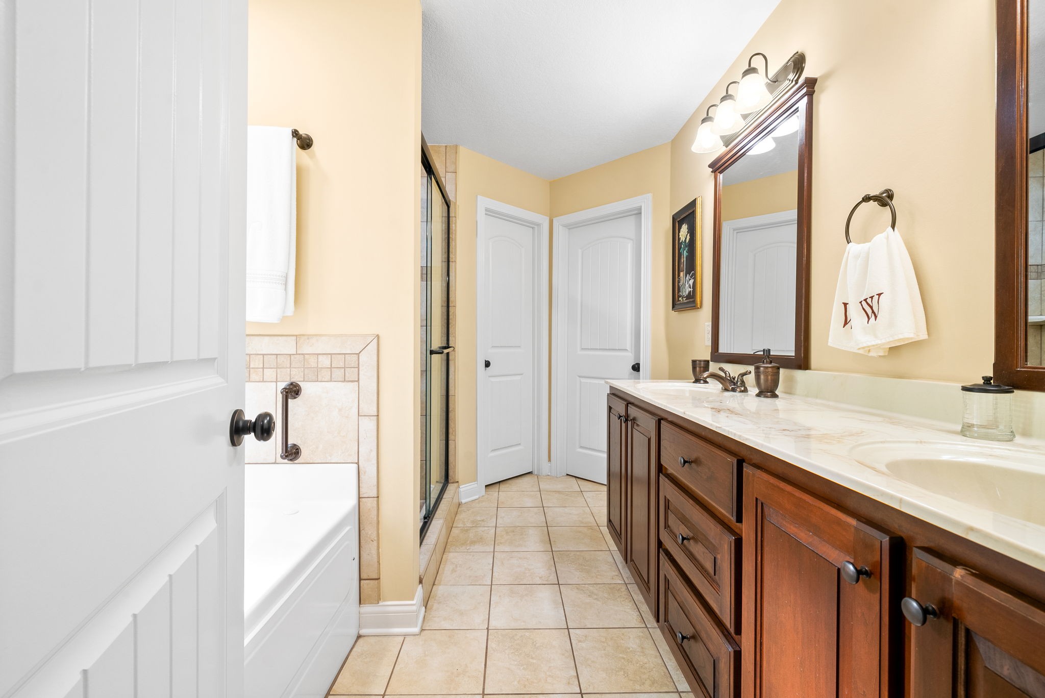 470 Salem Ridge Road Clarksville, TN 37040 - Photo 26 of 69 a spacious bathroom with a double vanity sink a mirror and a bathtub